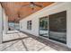 Covered patio with brick floor, ceiling fans, and sliding glass doors at 10231 Lenox St, Clermont, FL 34711