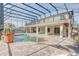 Lovely screened in pool area with an upper deck, spacious patio, and lush landscaping at 10231 Lenox St, Clermont, FL 34711