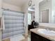 This bathroom features a vanity, shower, and white robe, offering convenience at 1061 Suffragatte Cir, Haines City, FL 33844