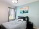 Relaxing bedroom with a black headboard, a soft blue color scheme, and a bright window at 1061 Suffragatte Cir, Haines City, FL 33844