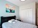 Relaxing bedroom with a black headboard, a soft blue color scheme, and a spacious closet at 1061 Suffragatte Cir, Haines City, FL 33844