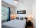 Cozy bedroom with a full bed, a ceiling fan, and a large window for natural light at 1061 Suffragatte Cir, Haines City, FL 33844