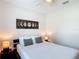 Cozy bedroom with a full bed, soft lighting, and moon phase wall art at 1061 Suffragatte Cir, Haines City, FL 33844