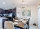 The dining room showcases a wooden table set for six, with an eye-catching light fixture at 1061 Suffragatte Cir, Haines City, FL 33844
