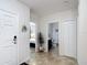 Inviting home foyer featuring tiled floors, neutral walls, and views into the bedroom and bathroom at 1061 Suffragatte Cir, Haines City, FL 33844