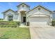 Attractive single-Gathering residence with a two-car garage, and well-kept lawn with manicured bushes at 1061 Suffragatte Cir, Haines City, FL 33844
