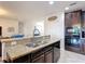 Granite countertops accent this kitchen island with undermount sink and stainless steel faucet at 1061 Suffragatte Cir, Haines City, FL 33844