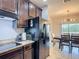 Modern kitchen featuring stainless steel appliances and sleek dark wood cabinetry with granite countertops at 1061 Suffragatte Cir, Haines City, FL 33844