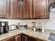 Well-equipped kitchen counter featuring a coffee maker, toaster, blender, and attractive granite countertops at 1061 Suffragatte Cir, Haines City, FL 33844