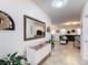 Welcoming home entrance featuring tile flooring, a console table, and an open view into the living room at 1061 Suffragatte Cir, Haines City, FL 33844