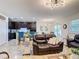 Open-concept living room view into the kitchen and dining area featuring modern decor and comfortable seating at 1061 Suffragatte Cir, Haines City, FL 33844