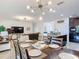 Spacious open floor plan featuring a dining area and a living area seamlessly connected to the kitchen at 1061 Suffragatte Cir, Haines City, FL 33844