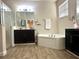 Spacious bathroom with double vanities, a soaking tub, separate shower, and tile floors at 1062 Rock Creek St, Apopka, FL 32712