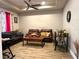 Cozy living room featuring a tray ceiling, modern furnishings and wood-look tile flooring at 1062 Rock Creek St, Apopka, FL 32712