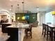 Open-concept living space with pendant lighting, dining area, tile floors and a green accent wall at 1062 Rock Creek St, Apopka, FL 32712
