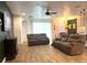 Comfortable living room with wood-look tile flooring, ceiling fan, and a green accent wall at 1062 Rock Creek St, Apopka, FL 32712