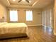 A primary bedroom showcases a ceiling fan, neutral walls and a sliding glass door at 1062 Rock Creek St, Apopka, FL 32712