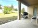 Covered patio area with outdoor seating and a barbecue grill overlooking the backyard at 1062 Rock Creek St, Apopka, FL 32712