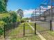 Backyard with a view of the screened lanai and pool from the fenced green yard at 1086 Calla Lily Cv, Oviedo, FL 32766