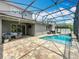 Expansive backyard with a screened pool, patio seating, and well-maintained landscaping for outdoor living at 1086 Calla Lily Cv, Oviedo, FL 32766