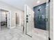 Bathroom featuring tiled shower with black fixtures, glass door, and access to walk-in closet at 1086 Calla Lily Cv, Oviedo, FL 32766