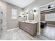Elegant bathroom boasting a double vanity, modern fixtures, and doorway view into main bedroom at 1086 Calla Lily Cv, Oviedo, FL 32766