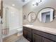 Updated bathroom with white subway tile shower and double vanity with oval mirrors at 1086 Calla Lily Cv, Oviedo, FL 32766