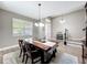 Charming dining area with a farmhouse-style table, wood floors, and natural light at 1086 Calla Lily Cv, Oviedo, FL 32766