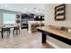 Stylish kitchen with dark cabinets, granite countertops, and stainless steel appliances next to a dining table at 1086 Calla Lily Cv, Oviedo, FL 32766