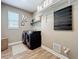Functional laundry room featuring modern washer and dryer set with wood-look flooring at 1086 Calla Lily Cv, Oviedo, FL 32766