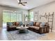 Inviting living room with comfortable seating, sliding doors to the lanai, and a ceiling fan at 1086 Calla Lily Cv, Oviedo, FL 32766