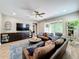 Inviting living room with comfortable seating, sliding doors to the lanai, and a ceiling fan at 1086 Calla Lily Cv, Oviedo, FL 32766