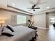 Large main bedroom with trey ceilings, tile floors, natural light, and a ceiling fan at 1086 Calla Lily Cv, Oviedo, FL 32766