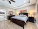 Spacious main bedroom features tile floors, tray ceilings, natural light, and a ceiling fan at 1086 Calla Lily Cv, Oviedo, FL 32766