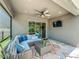 Comfortable covered patio with a stylish seating area, ceiling fan, and outdoor TV for entertainment at 1086 Calla Lily Cv, Oviedo, FL 32766