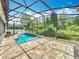 Sparkling pool with a screened enclosure, stone accents and a spacious deck, perfect for outdoor enjoyment at 1086 Calla Lily Cv, Oviedo, FL 32766