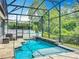 Screened pool with waterfall feature, deck, and a view of the backyard, offering a private oasis at 1086 Calla Lily Cv, Oviedo, FL 32766