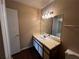 Bathroom with a single vanity, a mirror, and white cabinets at 1089 S Hiawassee Rd # 323, Orlando, FL 32835