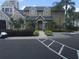 Inviting condo exterior with meticulous landscaping, paved walkway, and convenient parking at 1089 S Hiawassee Rd # 323, Orlando, FL 32835