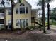Building exterior with stairs, complemented by mature trees and tropical landscaping at 1089 S Hiawassee Rd # 323, Orlando, FL 32835