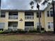 Inviting building exterior with well-maintained balconies and lush, tropical landscaping at 1089 S Hiawassee Rd # 323, Orlando, FL 32835