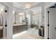 Well-lit bathroom featuring double vanity, glass-enclosed shower, and modern fixtures at 1184 Fern Ave, Orlando, FL 32814