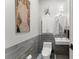 Small bathroom features a sleek toilet, modern tiling, and decorative painting at 1184 Fern Ave, Orlando, FL 32814