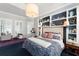 Inviting bedroom features a built-in bookcase headboard, carpeted floors, and window shutters at 1184 Fern Ave, Orlando, FL 32814