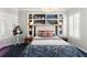 Inviting bedroom features a built-in bookcase headboard, carpeted floors, and window shutters at 1184 Fern Ave, Orlando, FL 32814
