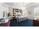 Inviting bedroom features a built-in bookcase headboard, carpeted floors, and window shutters at 1184 Fern Ave, Orlando, FL 32814