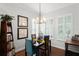 Cozy dining room with a stylish chandelier and comfortable seating for four at 1184 Fern Ave, Orlando, FL 32814