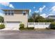 Two-story house features a two-car garage, a well-kept lawn, and a charming fence at 1184 Fern Ave, Orlando, FL 32814