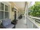 Spacious front porch with cozy seating, elegant columns, and decorative lanterns, perfect for relaxing outdoors at 1184 Fern Ave, Orlando, FL 32814