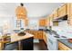 Bright kitchen features wooden cabinets, modern appliances, and a stylish island with seating at 1184 Fern Ave, Orlando, FL 32814